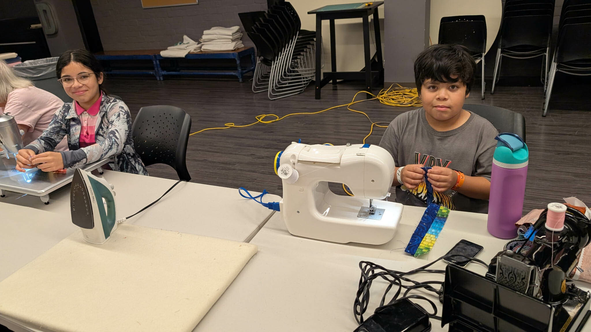 Elementary-school age volunteers sewing their first quilts.