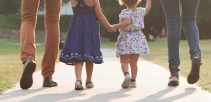 family walking down sidewalk