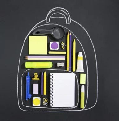 chalk outline drawing of backpack around some school supplies