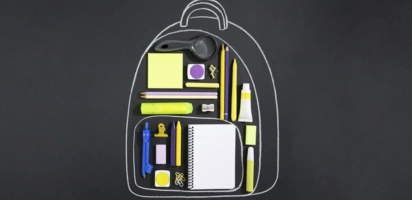 chalk outline drawing of backpack around some school supplies